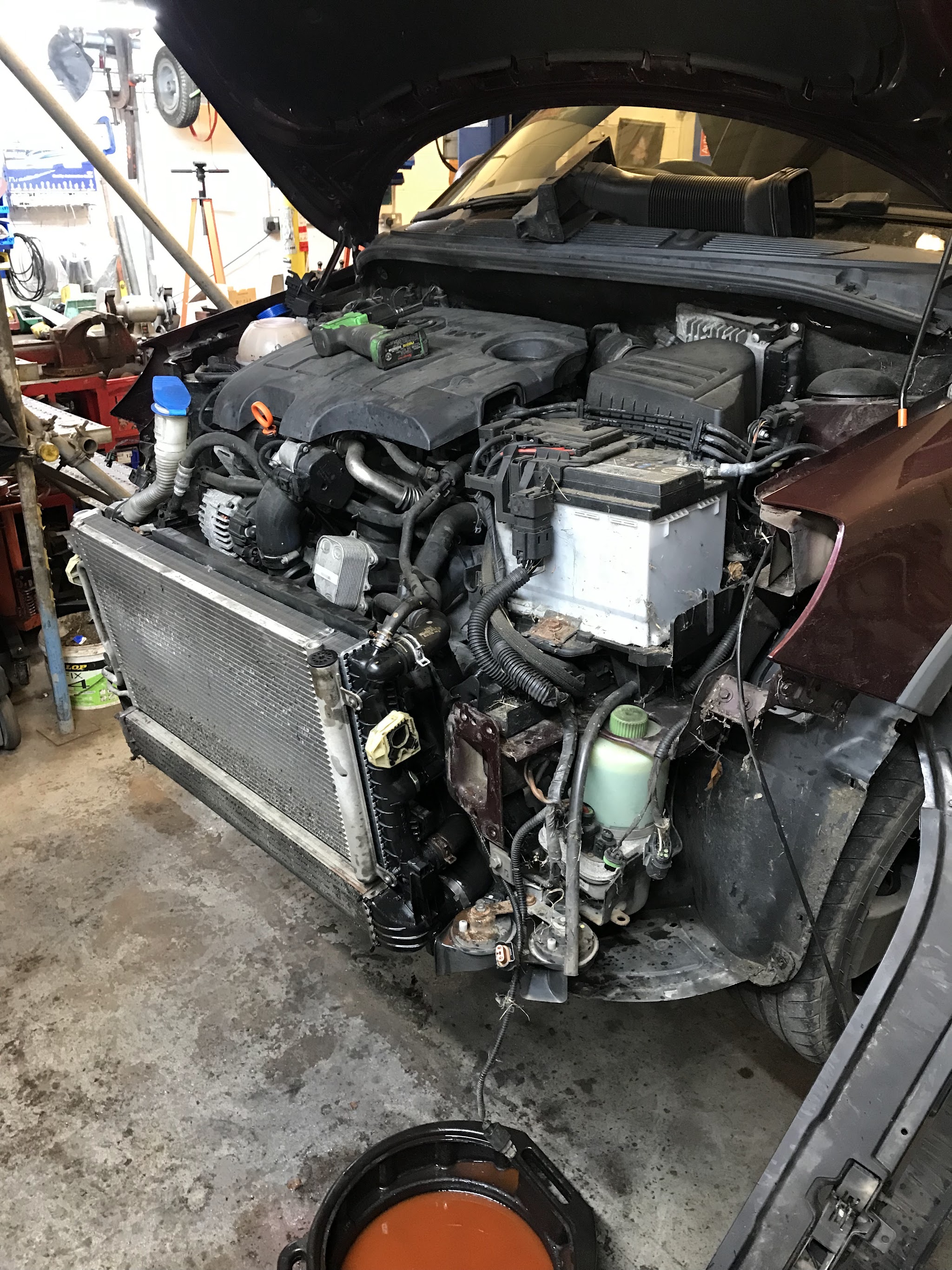 Engine bay stripped down with the front end off in the workshop